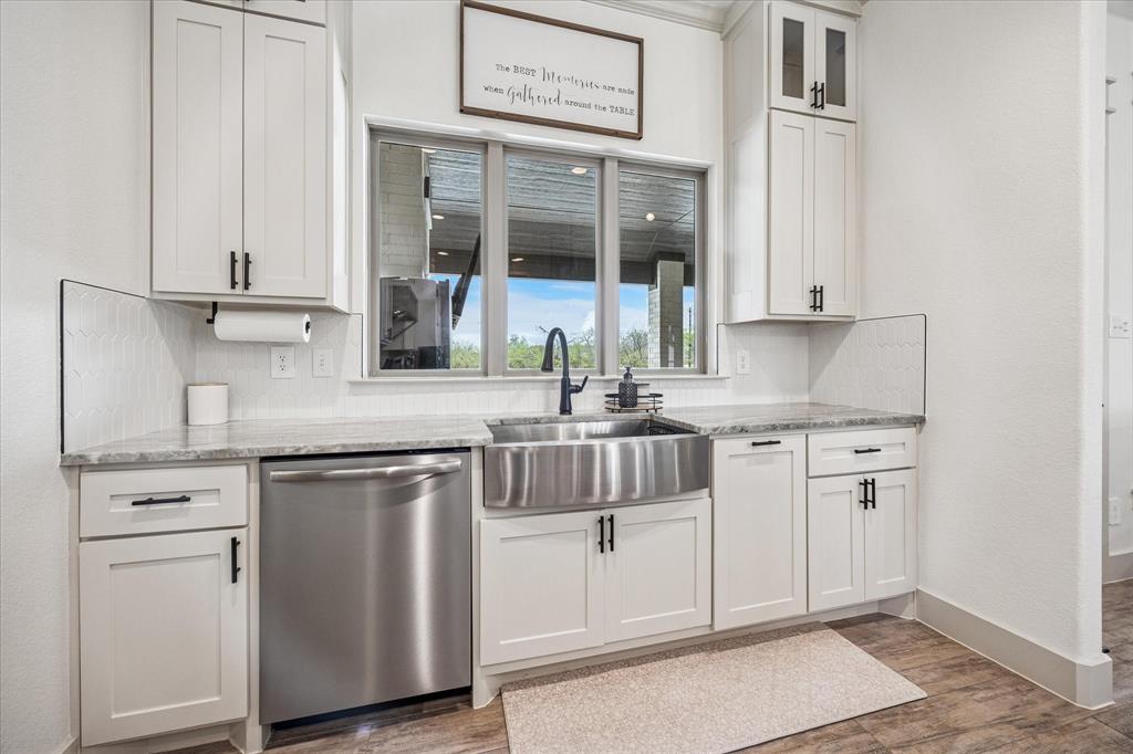 2028 Carrie Court Weatherford, TX 76088 - Photo 15 of 40 a kitchen with stainless steel appliances granite countertop a sink and cabinets