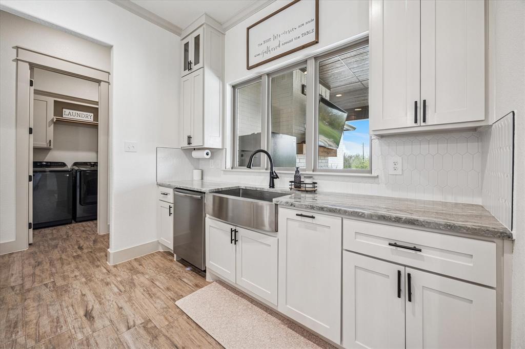 2028 Carrie Court Weatherford, TX 76088 - Photo 16 of 40 a kitchen with stainless steel appliances granite countertop a sink and cabinets