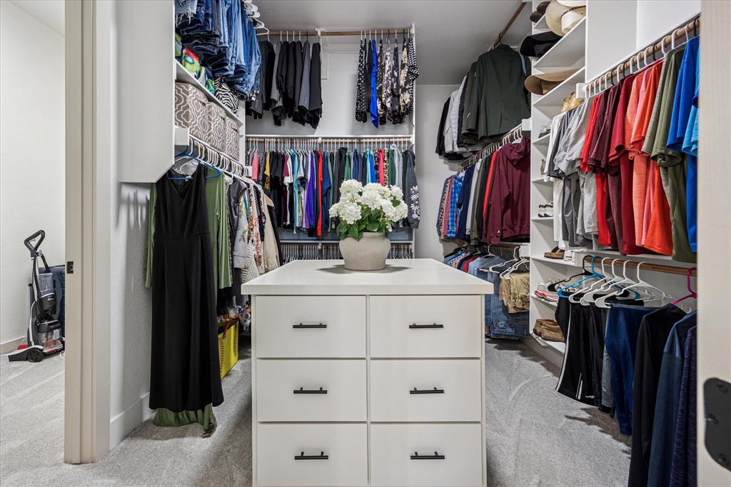 2028 Carrie Court Weatherford, TX 76088 - Photo 25 of 40 a view of walk in closet with clothes and shoes