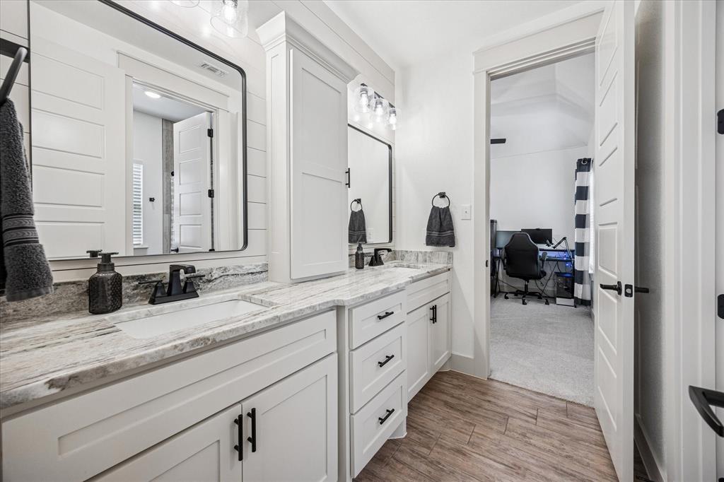 2028 Carrie Court Weatherford, TX 76088 - Photo 27 of 40 a en suite bathroom with double sink and a mirror