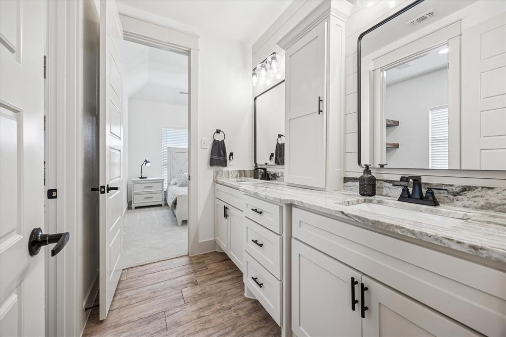2028 Carrie Court Weatherford, TX 76088 - Photo 28 of 40 a spacious bathroom with a double vanity sink and mirror