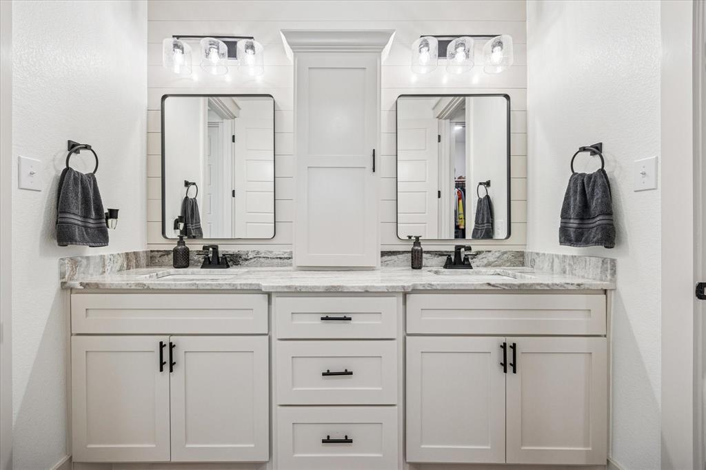 2028 Carrie Court Weatherford, TX 76088 - Photo 29 of 40 a bathroom with white cabinets and a sink