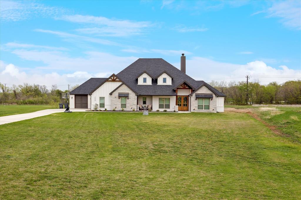 2028 Carrie Court Weatherford, TX 76088 - Photo 3 of 40 a front view of a house with garden