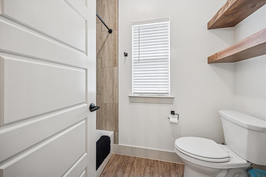 2028 Carrie Court Weatherford, TX 76088 - Photo 30 of 40 a bathroom with a toilet and a shower