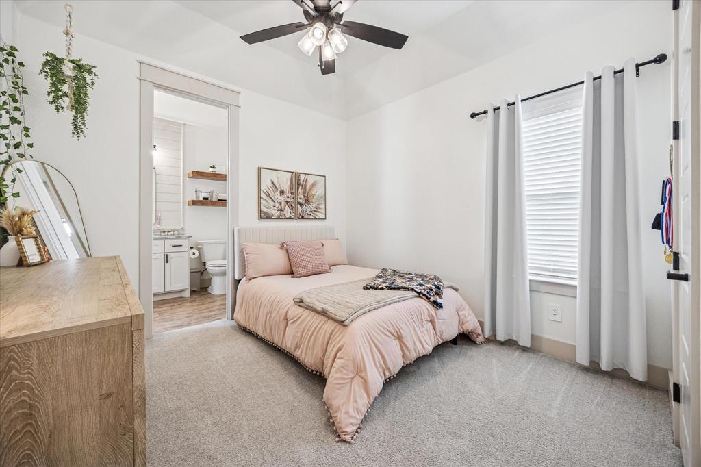 2028 Carrie Court Weatherford, TX 76088 - Photo 31 of 40 a spacious bedroom with a bed and a chandelier