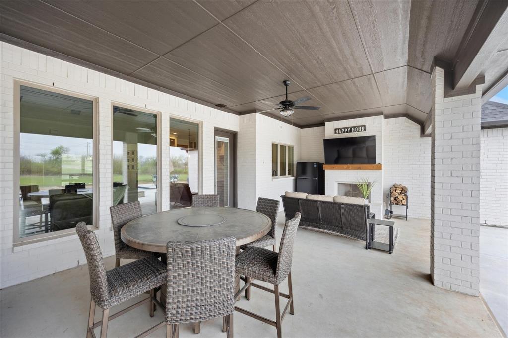 2028 Carrie Court Weatherford, TX 76088 - Photo 36 of 40 a view of a dining room with furniture window and wooden floor