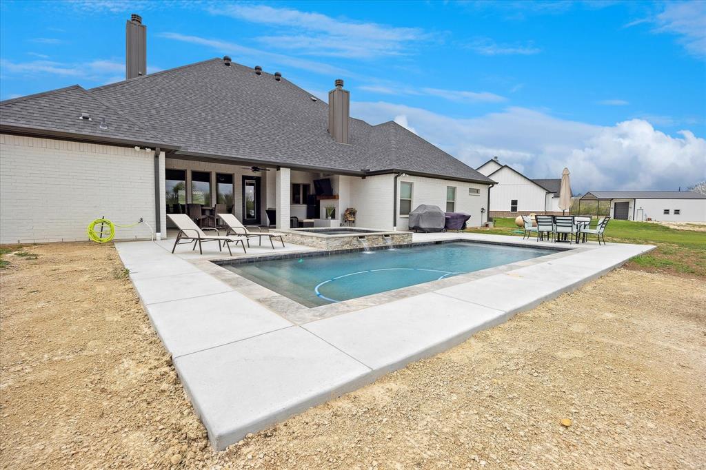 2028 Carrie Court Weatherford, TX 76088 - Photo 38 of 40 a view of a house with swimming pool and sitting area