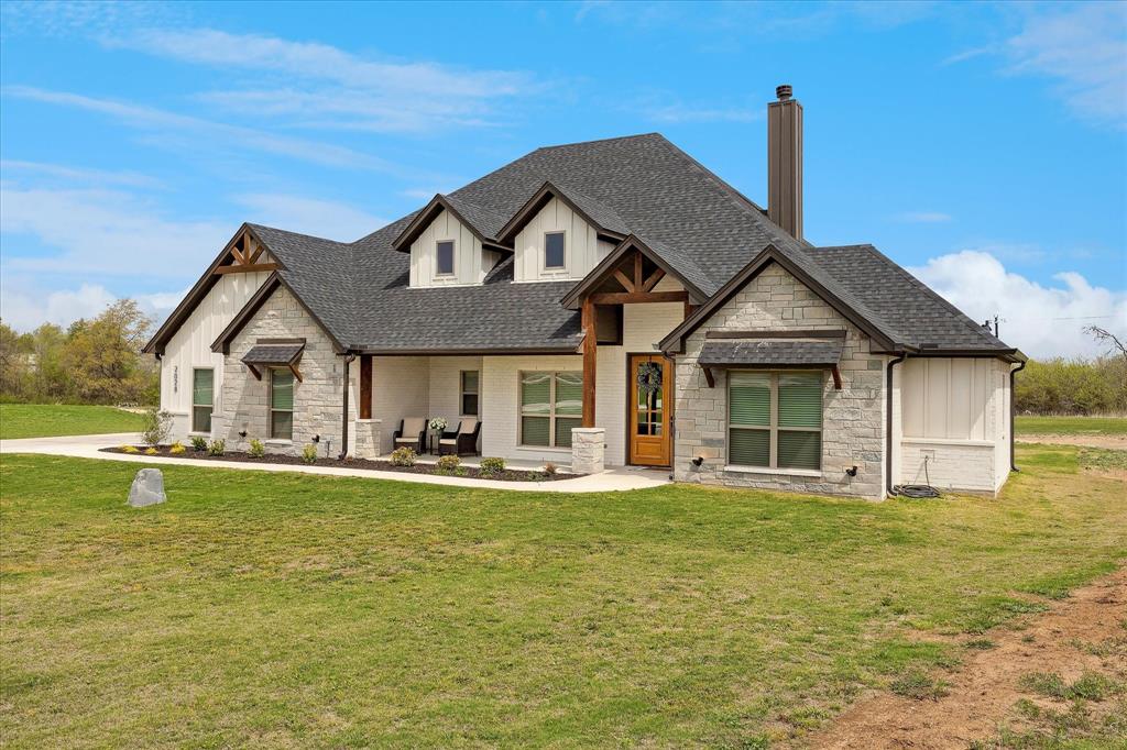 2028 Carrie Court Weatherford, TX 76088 - Photo 4 of 40 a front view of a house with a garden and lake view