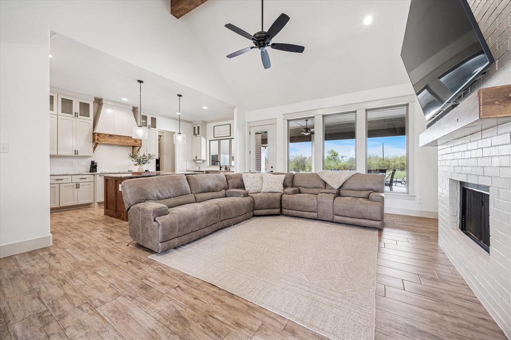 2028 Carrie Court Weatherford, TX 76088 - Photo 7 of 40 a living room with furniture and a fireplace