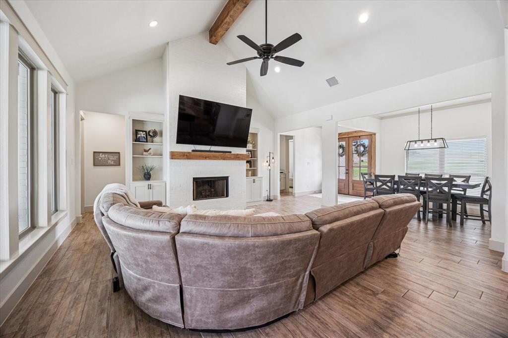 2028 Carrie Court Weatherford, TX 76088 - Photo 9 of 40 a living room with fireplace furniture and a flat screen tv