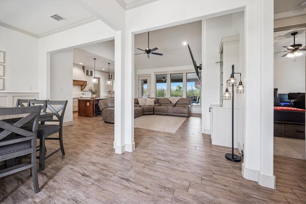 2028 Carrie Court Weatherford, TX 76088 - Photo 10 of 40 a view of a dining room with furniture wooden floor and a chandelier