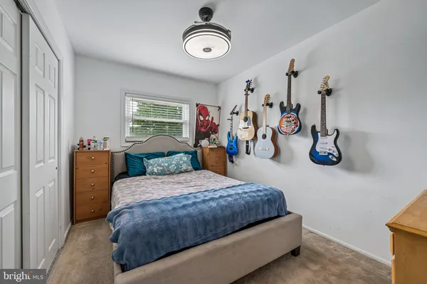 a bedroom with bed and a chandelier