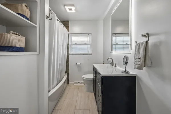 a en suite bathroom with a sink a toilet and a mirror