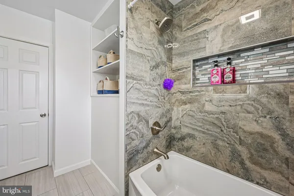 a bathroom with shower and a bathtub