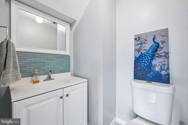 a bathroom with a sink mirror vanity and toilet
