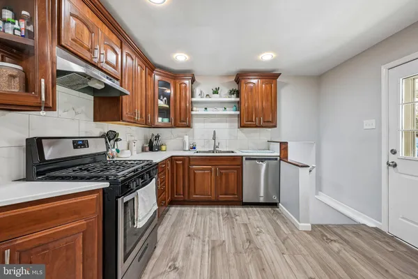 a kitchen with stainless steel appliances granite countertop a stove and a sink