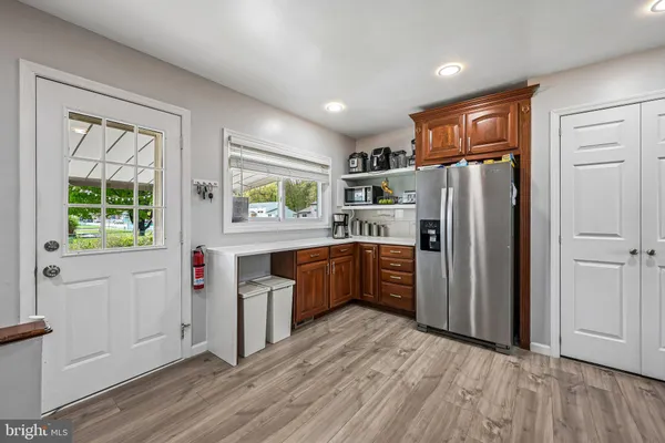 a kitchen with stainless steel appliances a refrigerator and a stove top oven