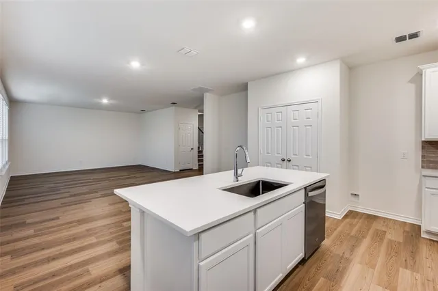 a kitchen with a sink and cabinets