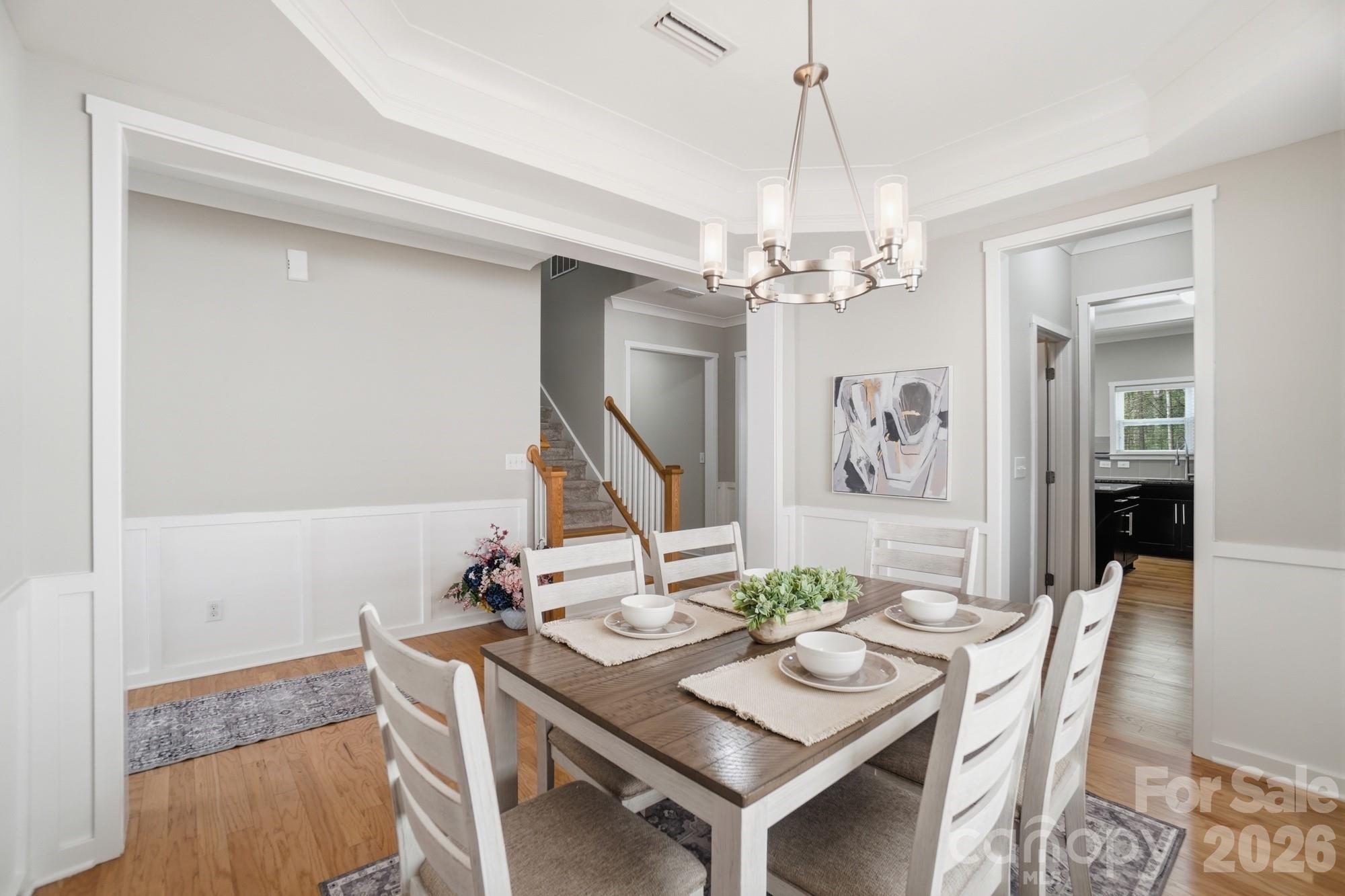 2153 Bluebell Way Tega Cay, SC 29708 - Photo 11 of 48 a view of a dining room with furniture and chandelier