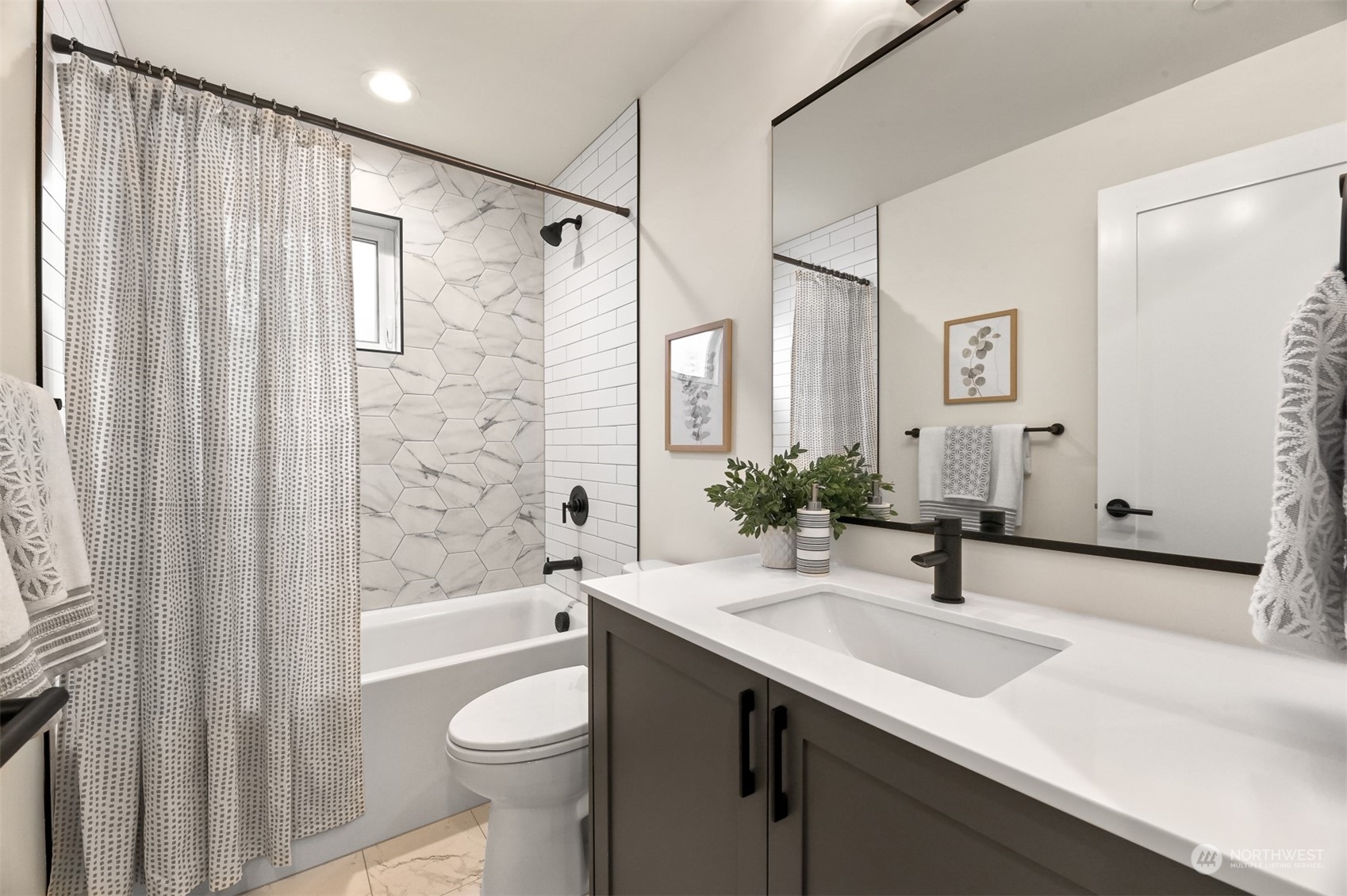 422 14th Avenue East, Unit B Seattle, WA 98112 - Photo 14 of 24 a bathroom with a sink a toilet and shower