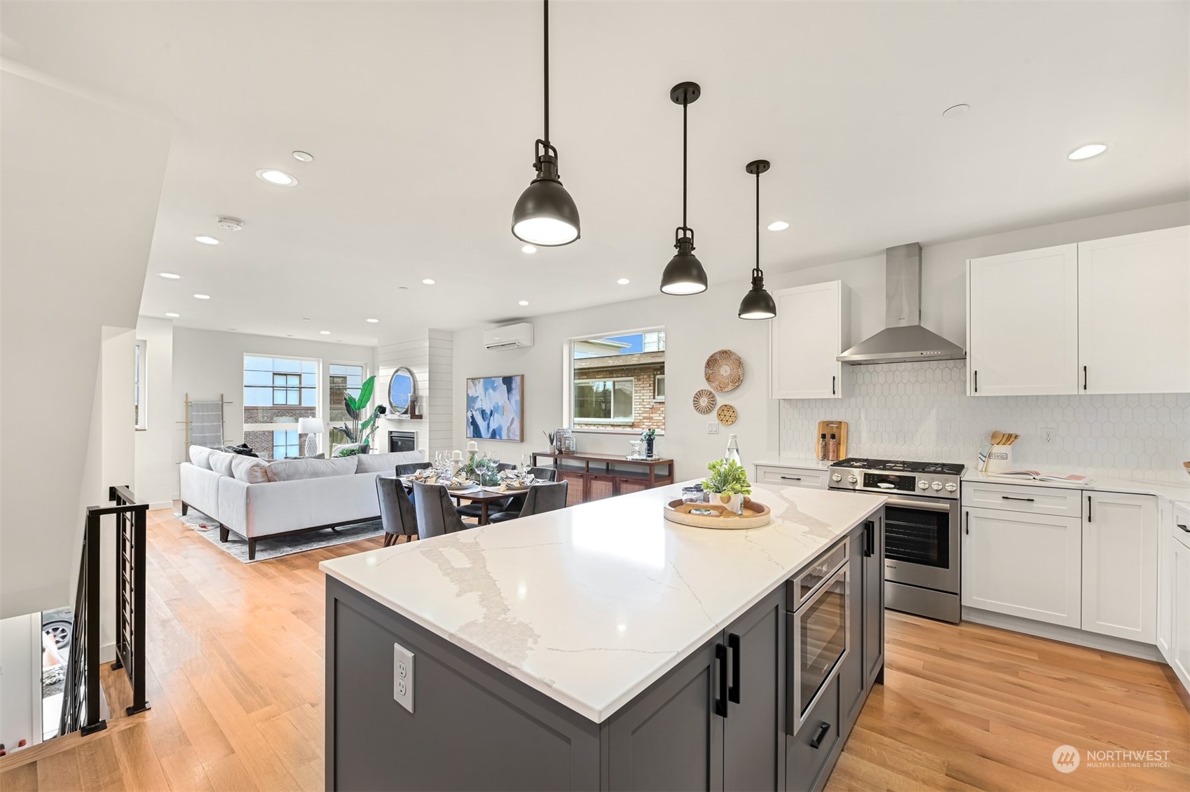 422 14th Avenue East, Unit B Seattle, WA 98112 - Photo 7 of 24 a large kitchen with kitchen island a large counter space a sink appliances and cabinets