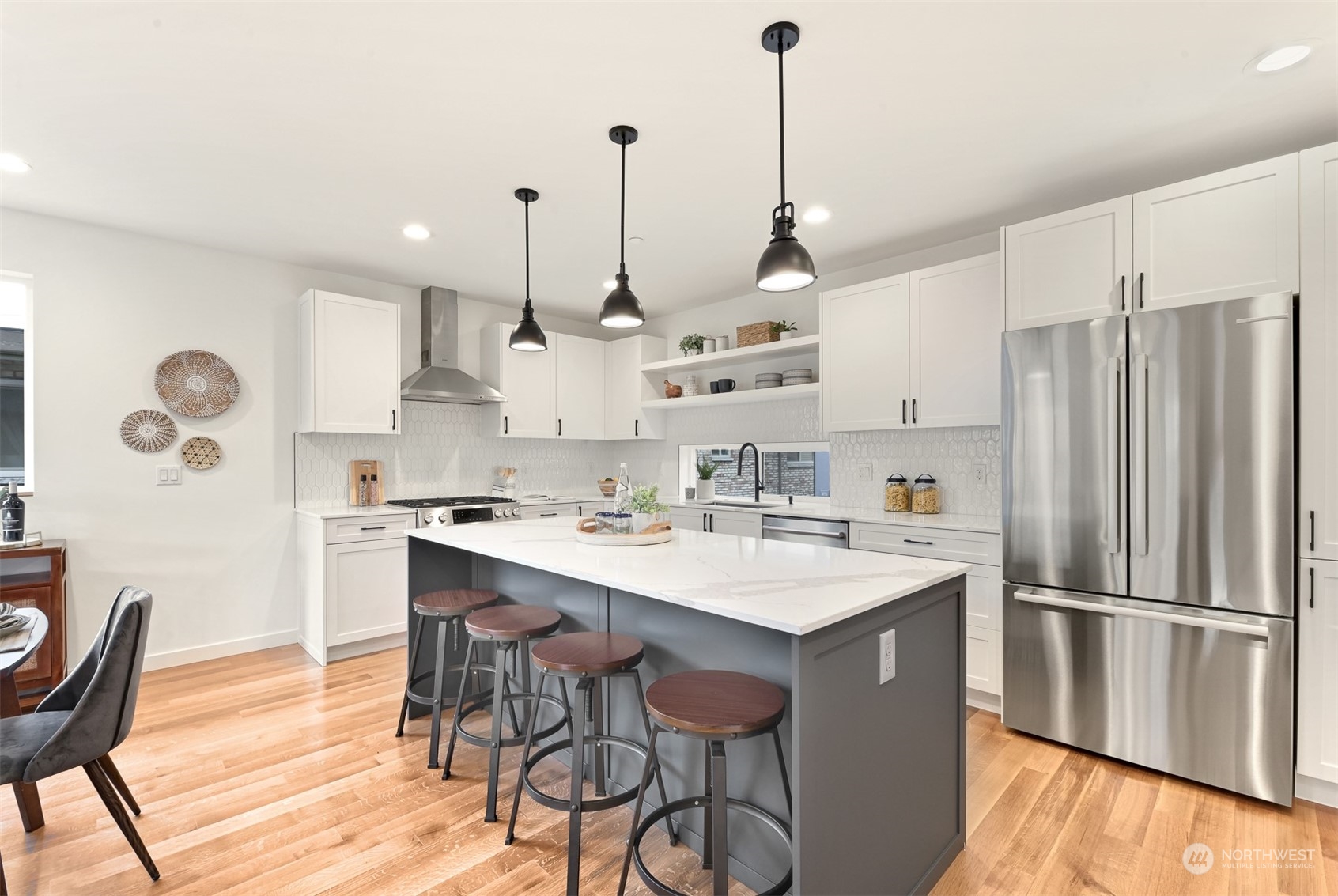 422 14th Avenue East, Unit B Seattle, WA 98112 - Photo 10 of 24 a kitchen with stainless steel appliances granite countertop a sink a stove a refrigerator and island with wooden floor