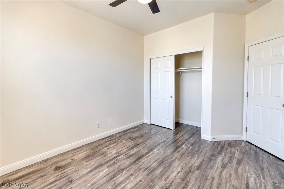 3104 Maple Ridge Court Henderson, NV 89052 - Photo 13 of 25 Smooth wood-grain flooring and towering ceilings define this versatile, neutral-toned interior space.