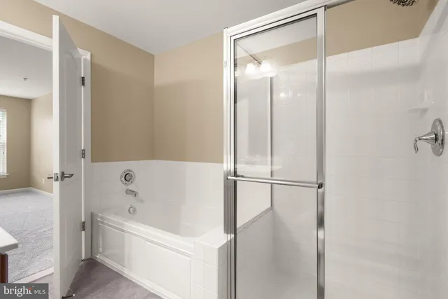 a white bath tub sitting next to a white sink