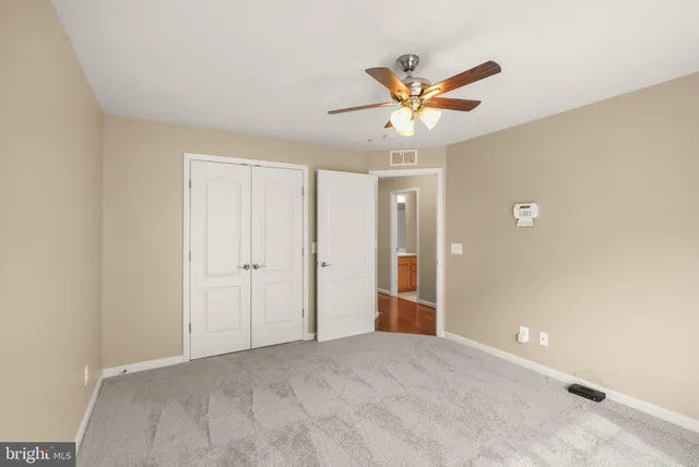 a view of a livingroom with a ceiling fan and window