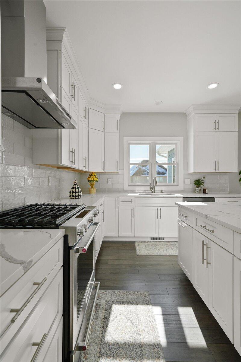 9317 Michigan Drive Crown Point, IN 46307 - Photo 11 of 42 a kitchen with granite countertop a stove top oven sink and cabinets