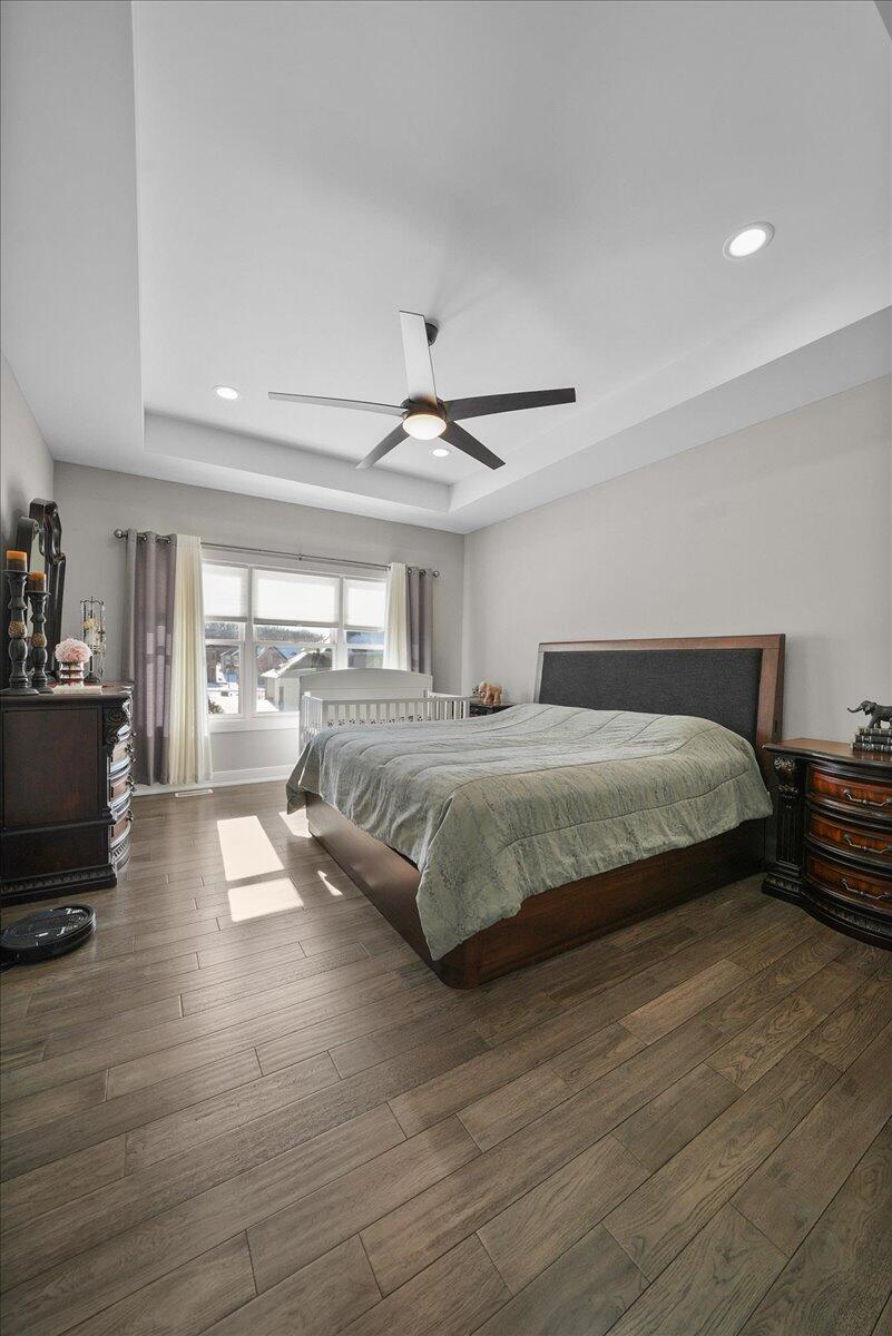 9317 Michigan Drive Crown Point, IN 46307 - Photo 13 of 42 a bedroom with a bed and wooden floor