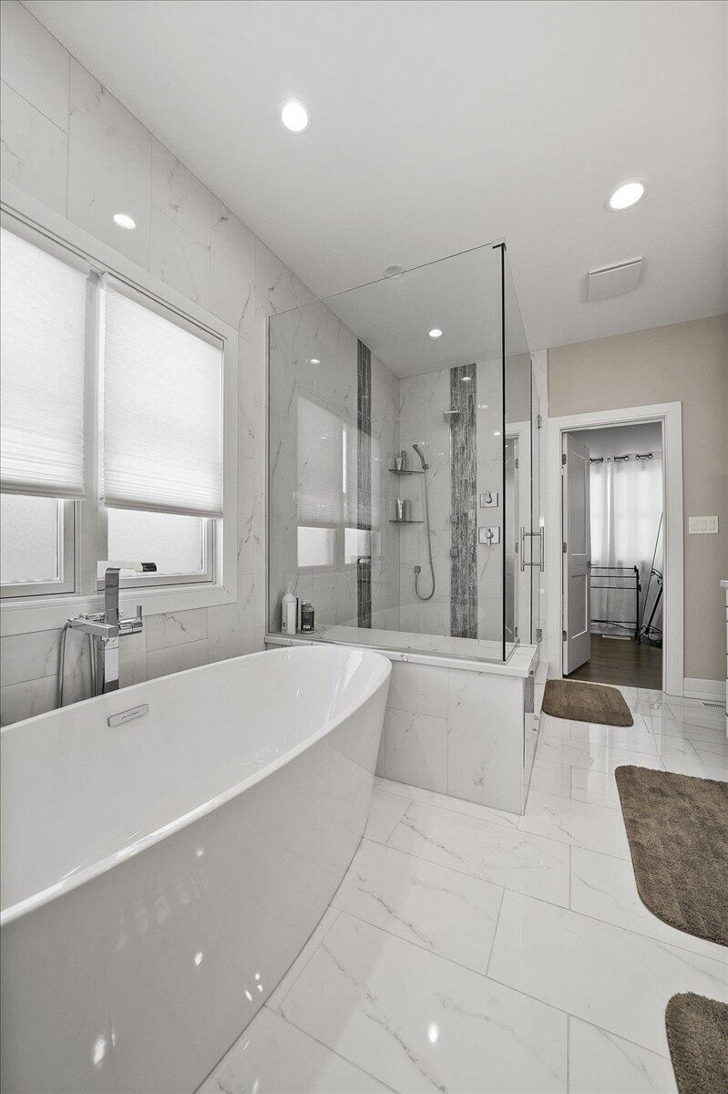 9317 Michigan Drive Crown Point, IN 46307 - Photo 14 of 42 a large spacious bathroom with a large tub shower and sink