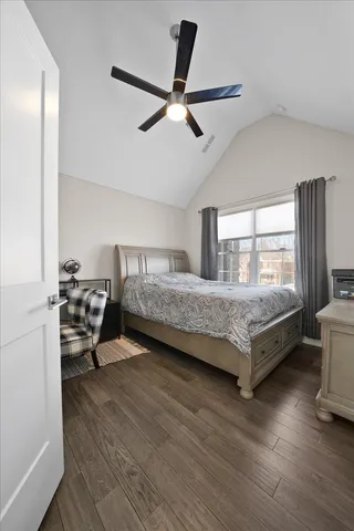 a bedroom with a large bed and a couch