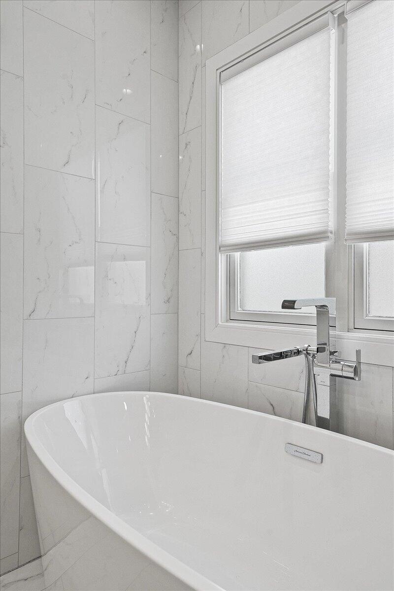 9317 Michigan Drive Crown Point, IN 46307 - Photo 19 of 42 a white bath tub sitting next to a window