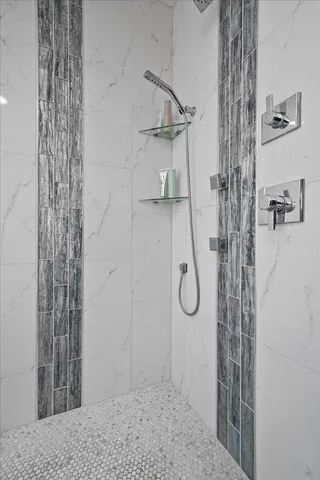 a living room with stainless steel appliances kitchen island granite countertop a refrigerator and a sink