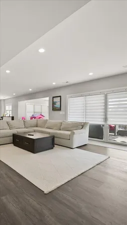 a living room with stainless steel appliances kitchen island granite countertop furniture and a couch