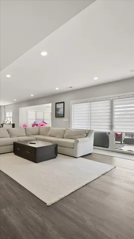 a living room with stainless steel appliances kitchen island granite countertop furniture and a couch
