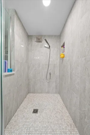 a spacious bathroom with a double vanity sink a mirror and a toilet