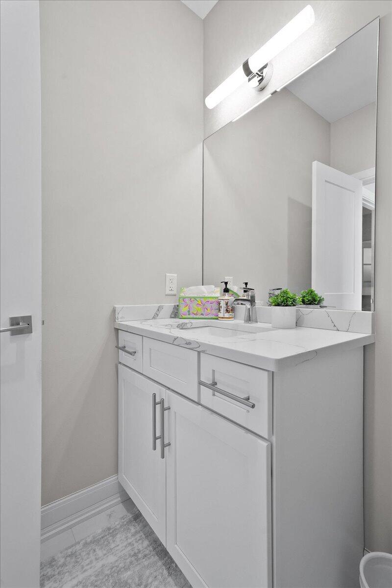 9317 Michigan Drive Crown Point, IN 46307 - Photo 35 of 42 a bathroom with a sink and a mirror