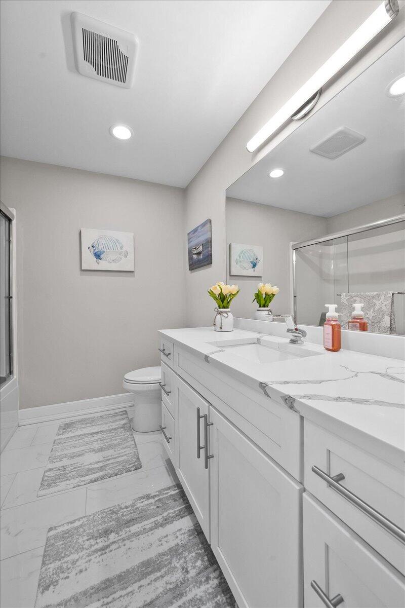 9317 Michigan Drive Crown Point, IN 46307 - Photo 39 of 42 a spacious bathroom with a sink a toilet and a shower