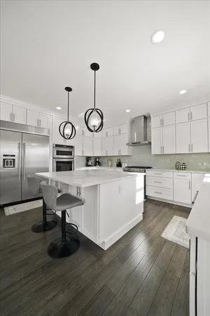 a kitchen with cabinets and wooden floors