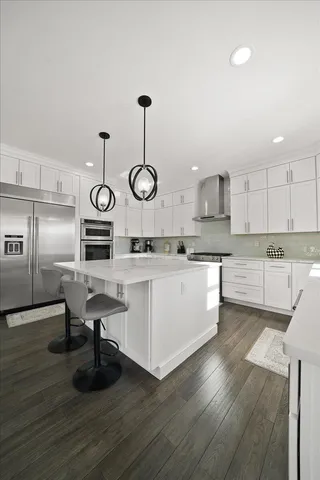 a kitchen with cabinets and wooden floors