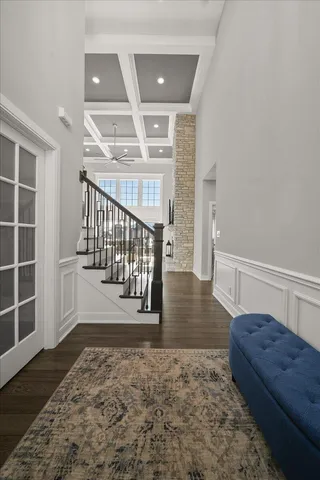 a view of entryway and hall with wooden floor