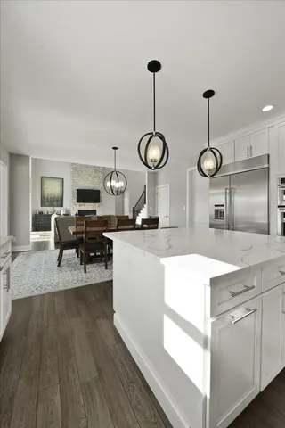 a kitchen with granite countertop a stove top oven sink and cabinets