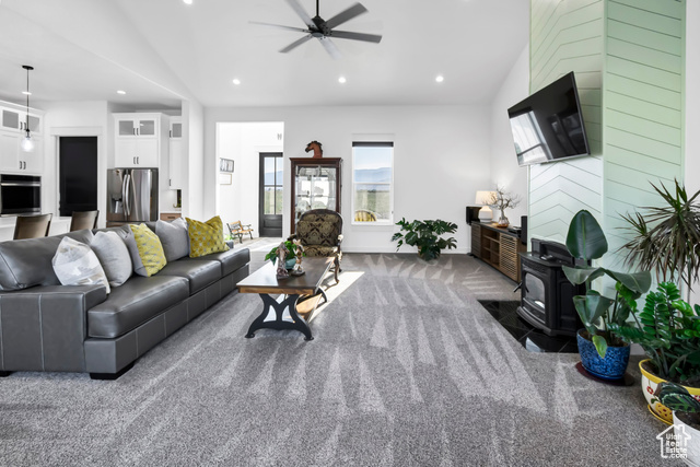 1952 Highway 118 Monroe, UT 84754 - Photo 16 of 88 Carpeted living area with a wood stove, ceiling fan, recessed lighting, and vaulted ceiling