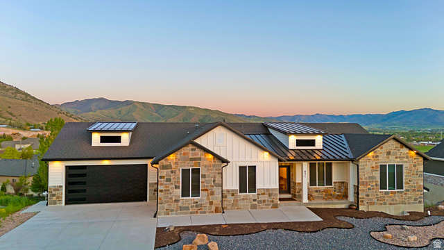 Undisclosed Address Morgan, UT 84050 - Photo 1 of 1 Ranch-style residence featuring a mixed-material facade with stone veneer and vertical white siding