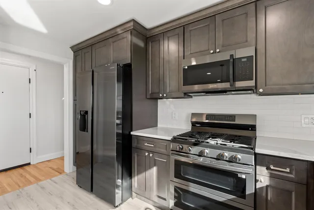a kitchen with cabinets and steel stainless steel appliances
