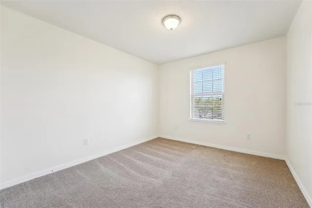an empty room with a empty space and windows