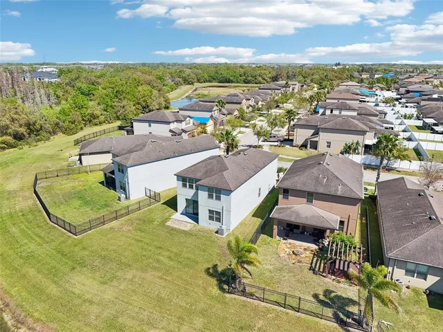 an aerial view of residential houses with outdoor space and river