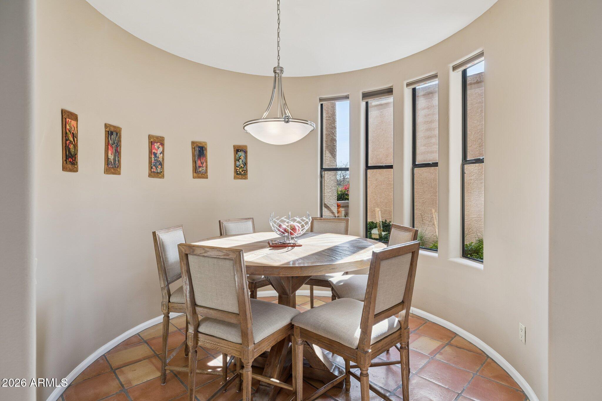 8100 East Camelback Road, Unit 129 Scottsdale, AZ 85251 - Photo 4 of 13 a view of a dining room with furniture window and wooden floor